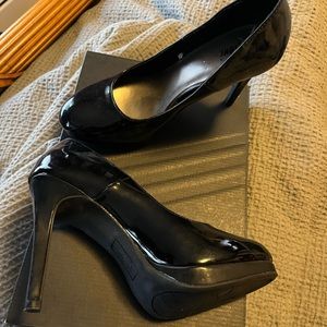 Black heel closed toe. Damage to one heel due to my dog.